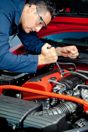 Michael, leaning over a high-performance engine with a wrench.